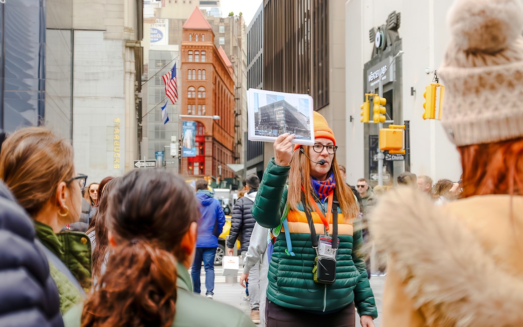 Tour guide in New York City showing a photo of the original World Trade Center.