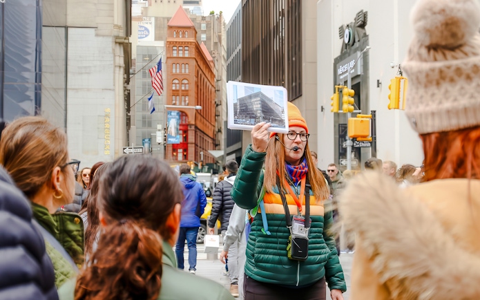 Tour guide in New York City showing a photo of the original World Trade Center.