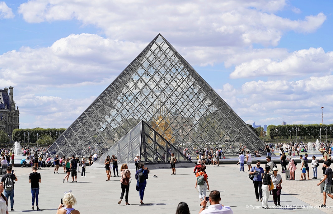 Louvre Museum glass pyramid entrance in Paris, France.