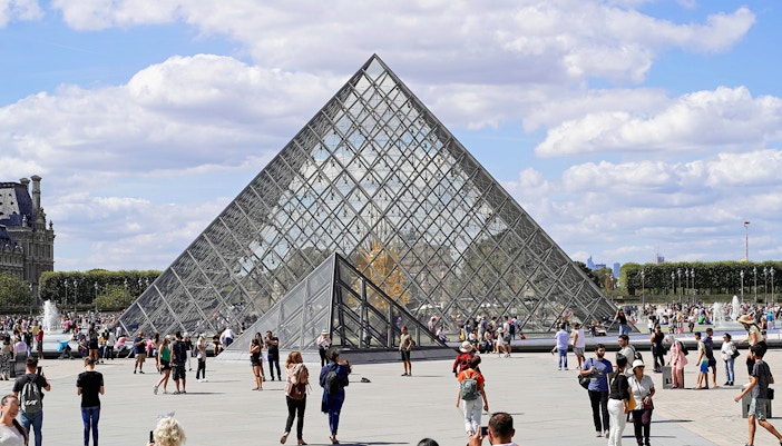 Louvre Museum glass pyramid entrance in Paris, France.