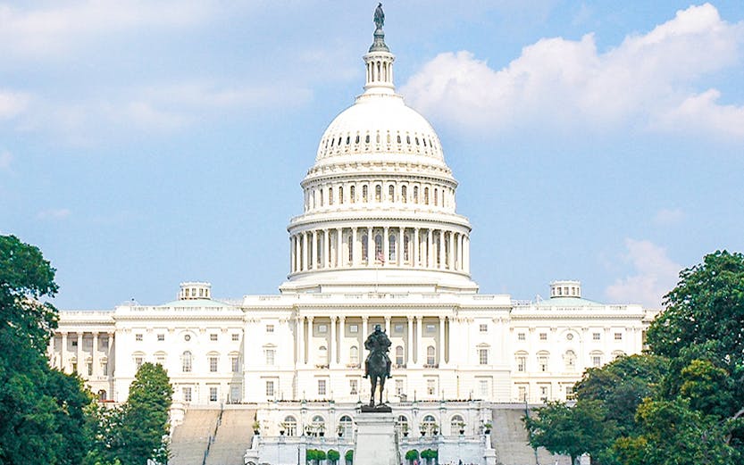 United States Capitol building with reflecting pool and statue in Washington, D.C.