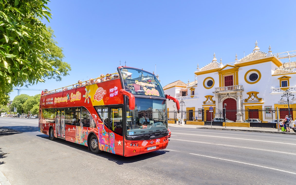 Open-top tour bus in front of Plaza de Toros, Seville.