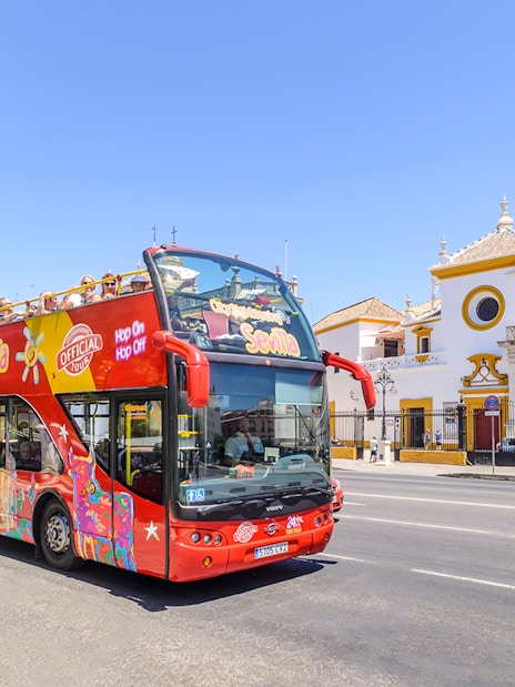 Open-top tour bus in front of Plaza de Toros, Seville.