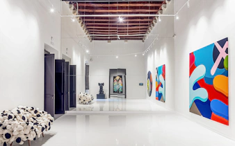 KAWS artwork displayed at Moco Museum in Barcelona gallery.