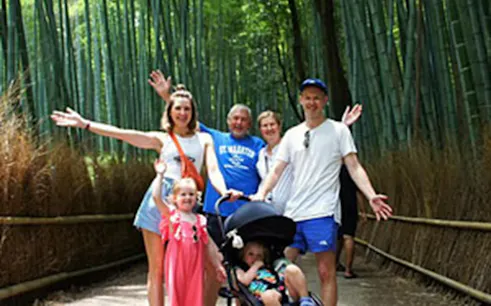 Family enjoying Arashiyama Bamboo Forest in Kyoto during a guided tour.