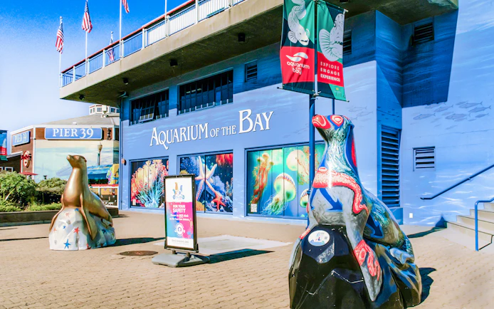 Aquarium of the Bay entrance with sea life murals and sculptures, San Francisco, California.
