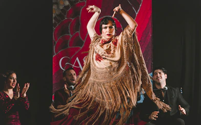 Flamenco dancer performing at Casa Ana with musicians in the background.