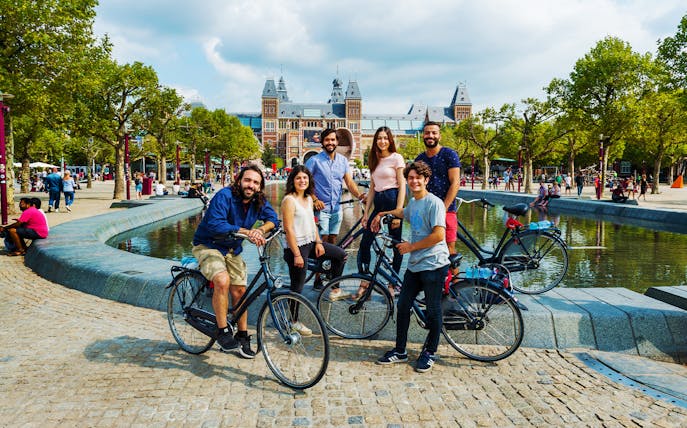 Group on bikes near Rijksmuseum during Amsterdam bike tour.