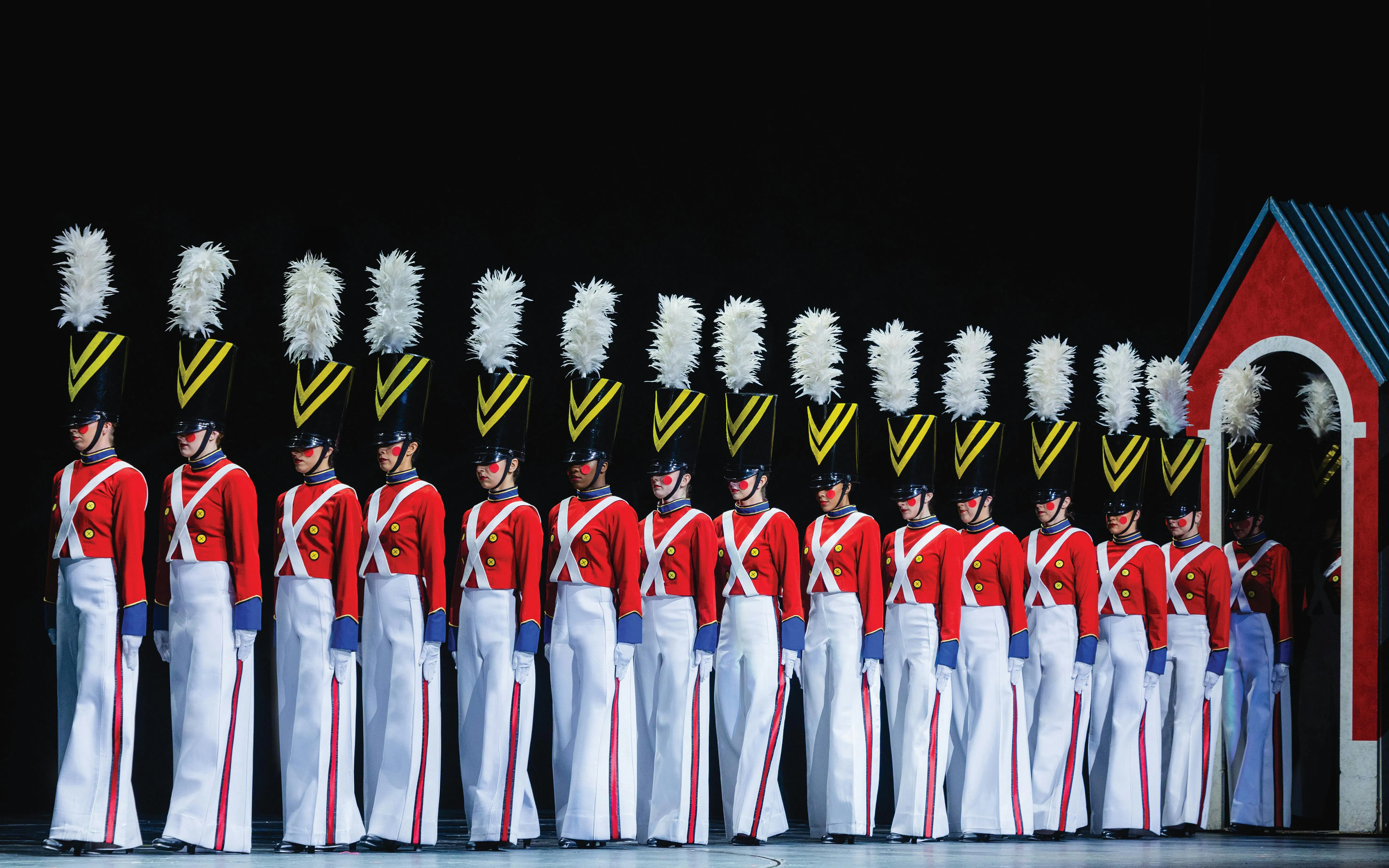 Radio City Rockettes in toy soldier costumes during Christmas Spectacular performance.