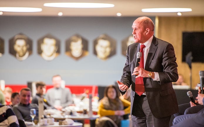 Liverpool FC legend speaking at a Q&A session during a stadium tour.