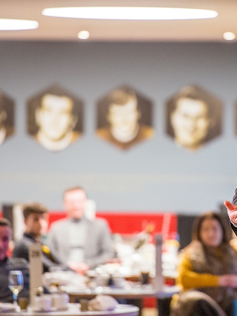 Liverpool FC legend speaking at a Q&A session during a stadium tour.