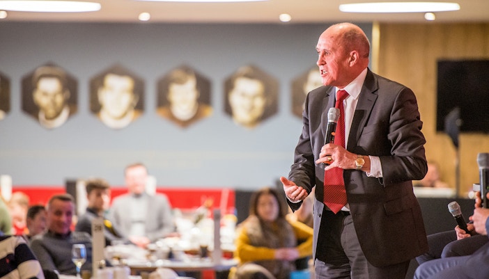 Liverpool FC legend speaking at a Q&A session during a stadium tour.