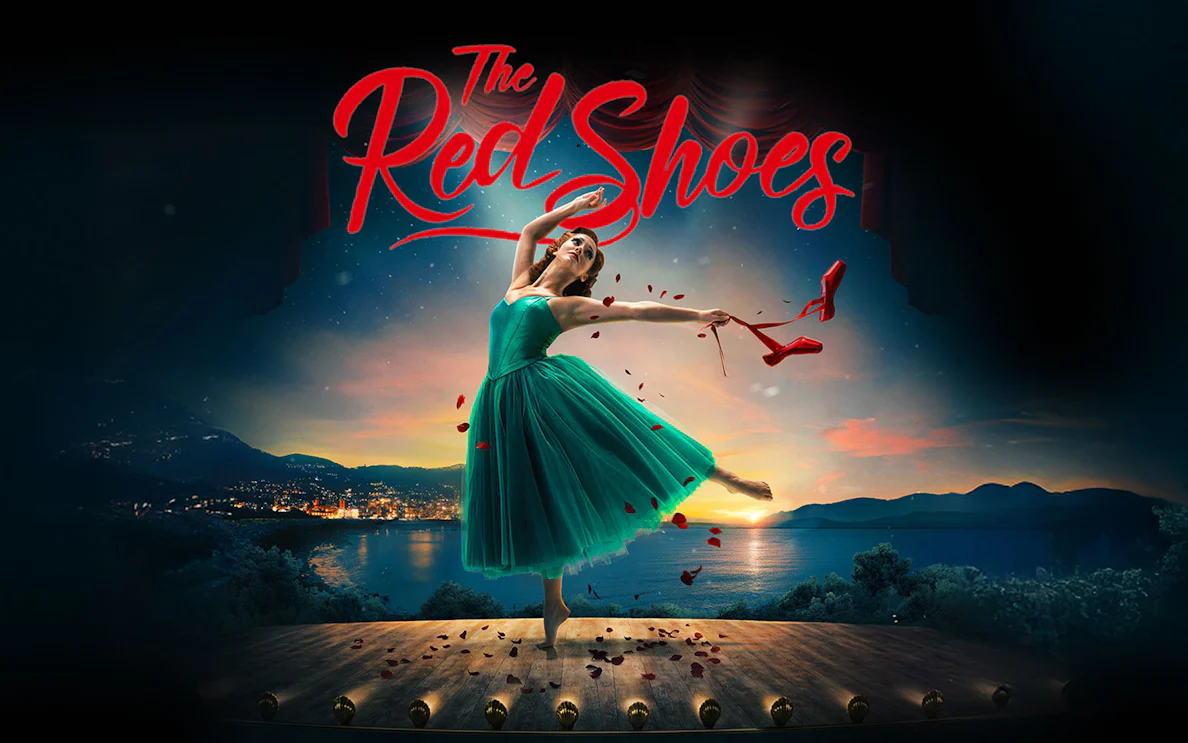 Ballet dancer on stage with red shoes in hand, backdrop of sunset over a lake, "The Red Shoes" text above.