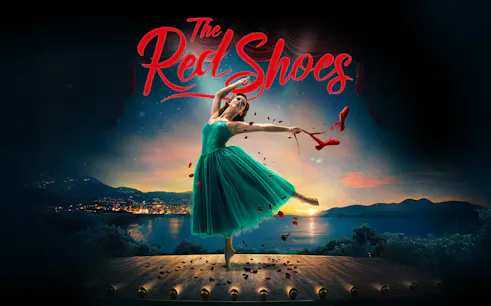 Ballet dancer on stage with red shoes in hand, backdrop of sunset over a lake, "The Red Shoes" text above.
