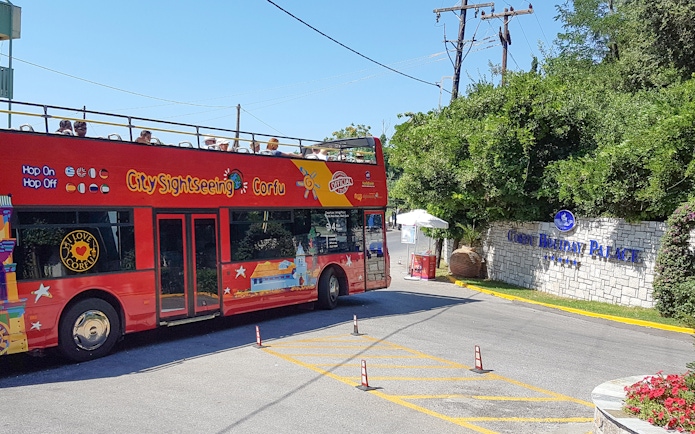 Red double-decker City Sightseeing bus near Corfu Holiday Palace entrance, Corfu.