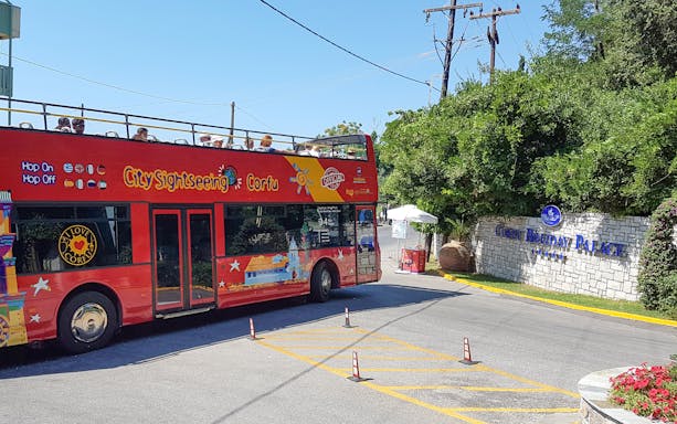 Red double-decker City Sightseeing bus near Corfu Holiday Palace entrance, Corfu.