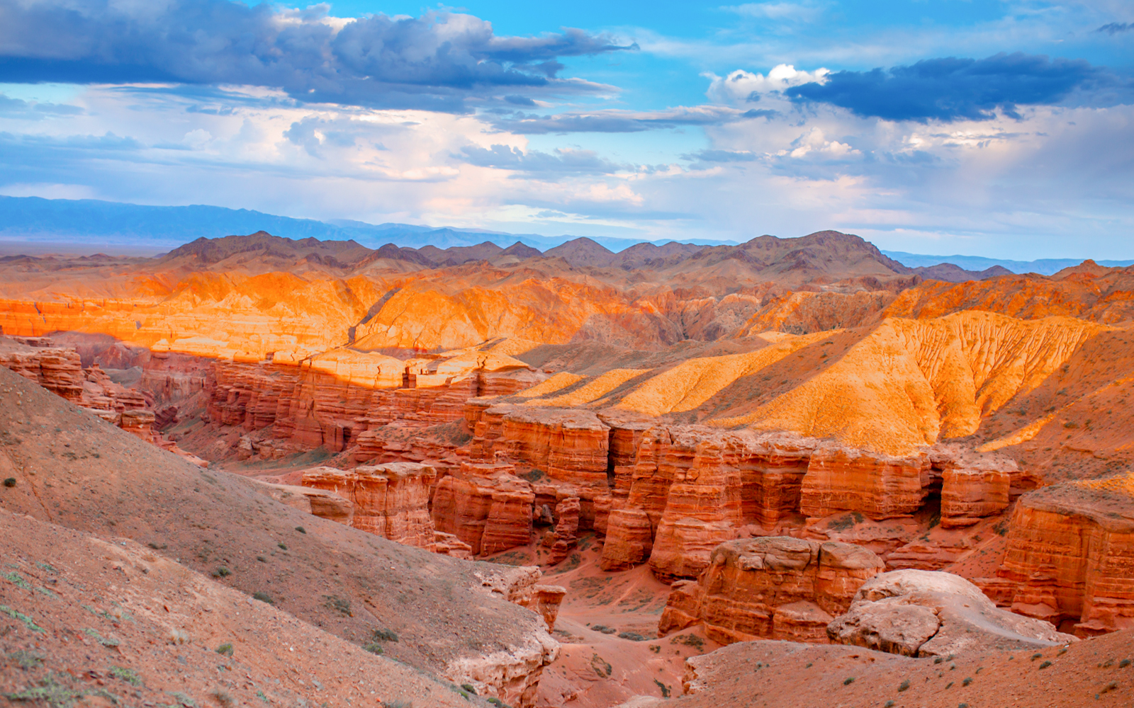Charyn Canyon's red rock formations under a clear sky in Kazakhstan.