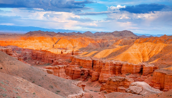 Charyn Canyon's red rock formations under a clear sky in Kazakhstan.
