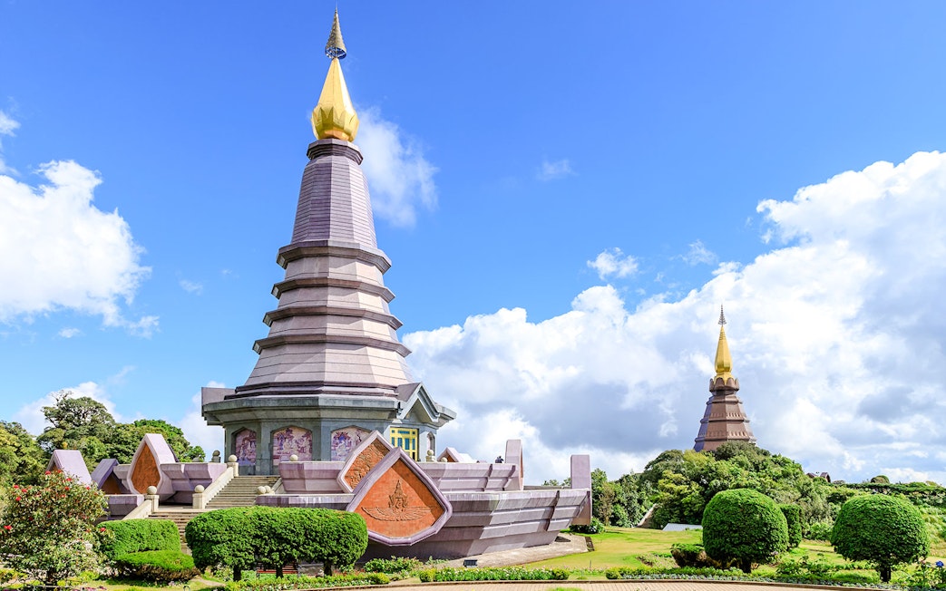 Twin pagodas at Doi Inthanon National Park, Chiang Mai, under a clear blue sky.