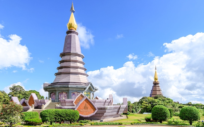 Twin pagodas at Doi Inthanon National Park, Chiang Mai, under a clear blue sky.