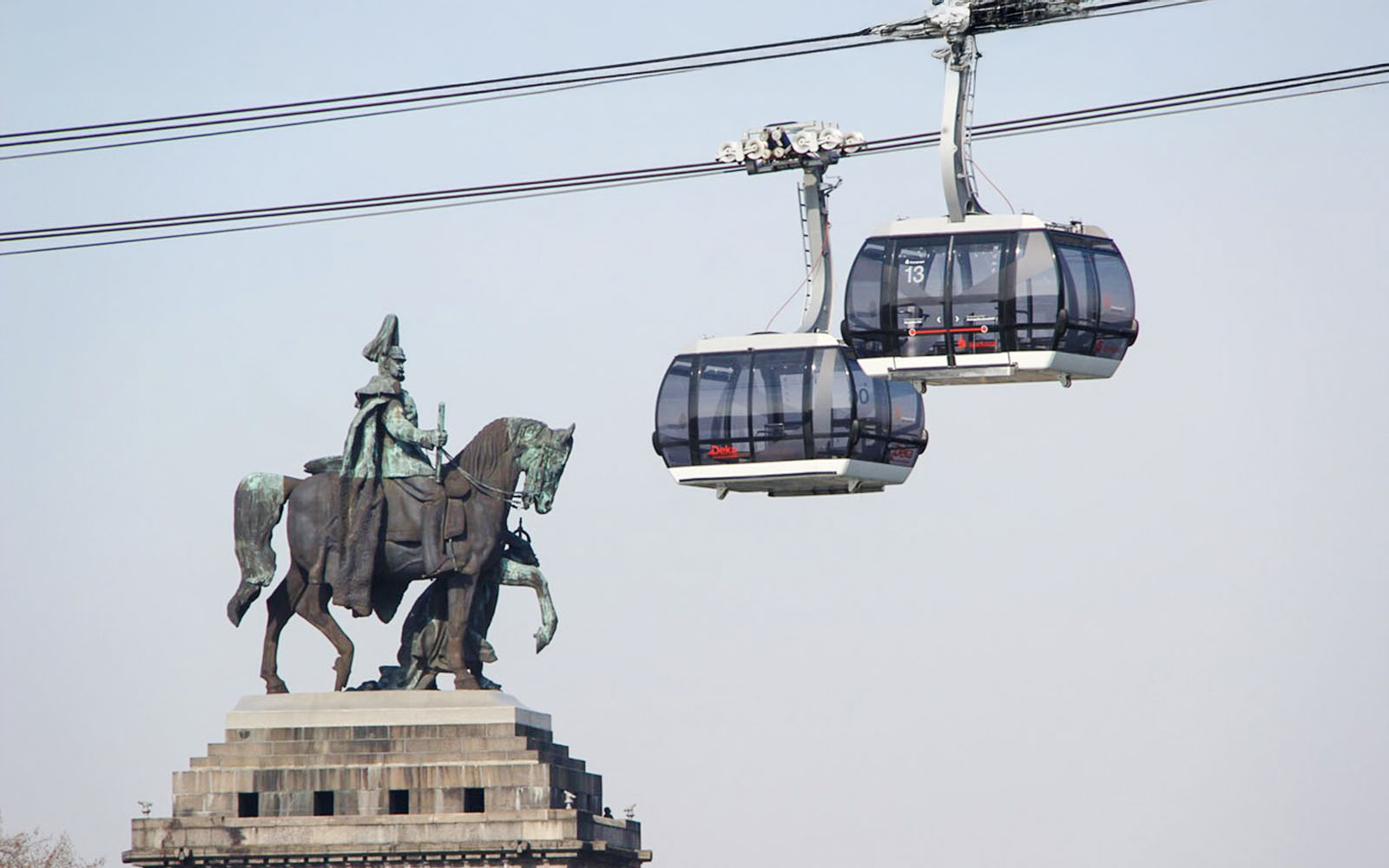 Koblenz Cable Car passing equestrian statue in Germany.