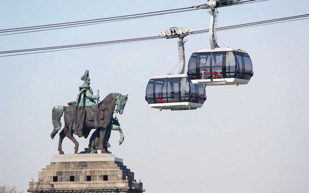 Koblenz Cable Car passing equestrian statue in Germany.