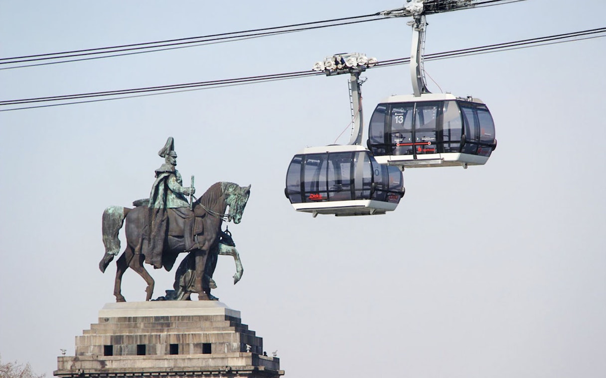 Koblenz Cable Car passing equestrian statue in Germany.