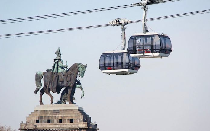 Koblenz Cable Car passing equestrian statue in Germany.