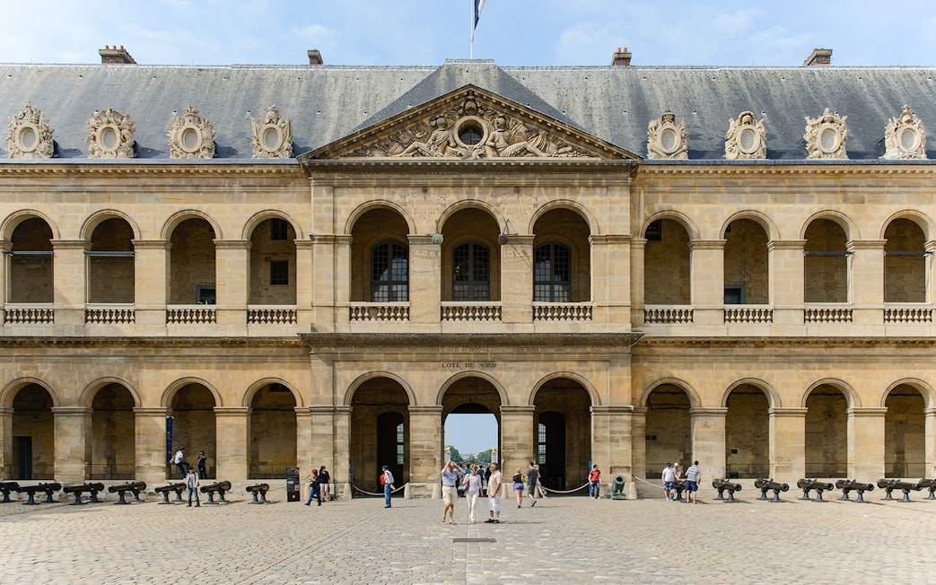 Invalides Courtyard with visitors, view of Napoleon's Tomb and Army Museum, Paris.