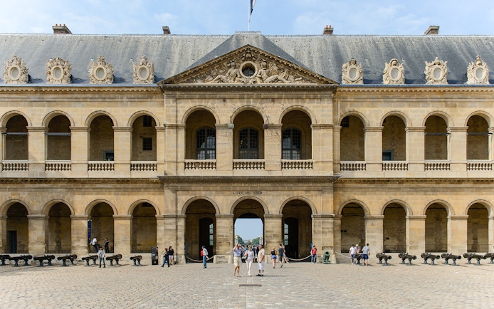 Invalides Courtyard with visitors, view of Napoleon's Tomb and Army Museum, Paris.