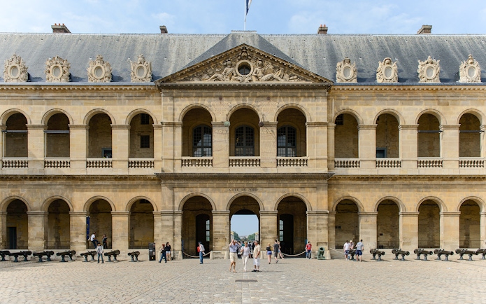 Invalides Courtyard with visitors, view of Napoleon's Tomb and Army Museum, Paris.