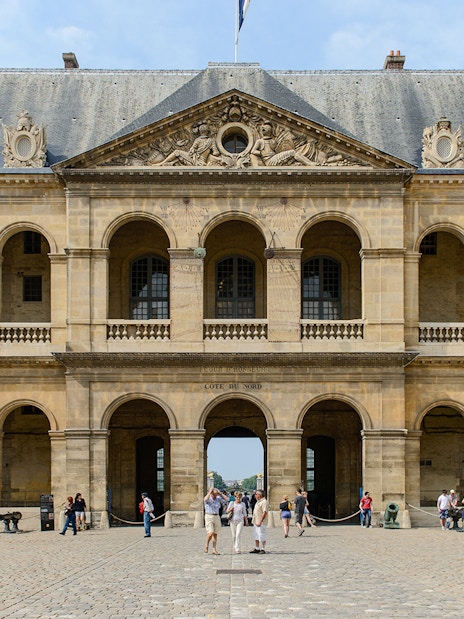 Invalides Courtyard with visitors, view of Napoleon's Tomb and Army Museum, Paris.