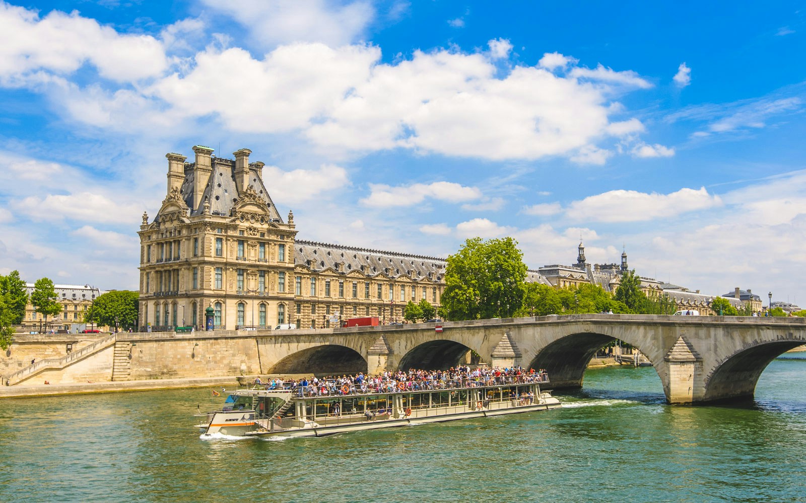 Seine River cruise with view of Musée d'Orsay and Pont Royal in Paris.