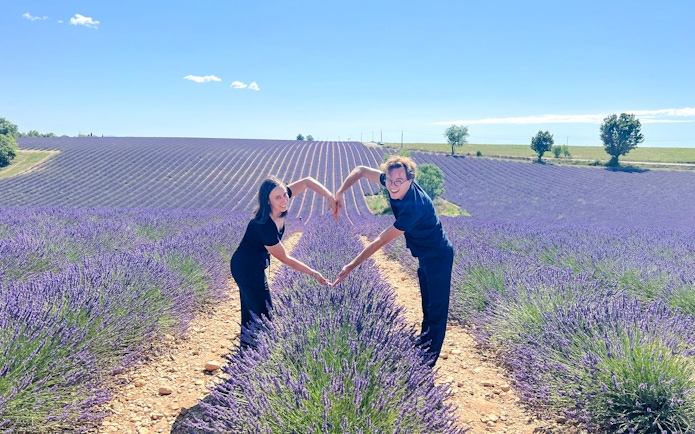 Couple forming heart shape in lavender fields, Valensole, Provence.