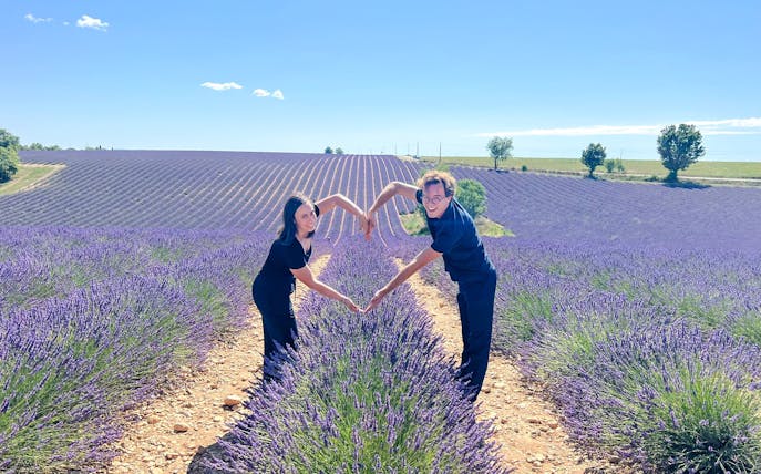 Couple forming heart shape in lavender fields, Valensole, Provence.
