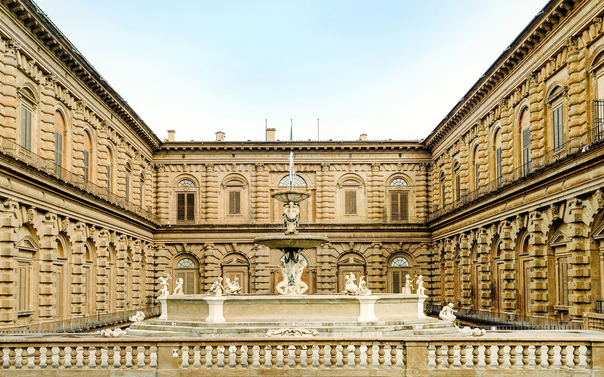 Palazzo Pitti courtyard with fountain and sculptures in Florence, Italy.