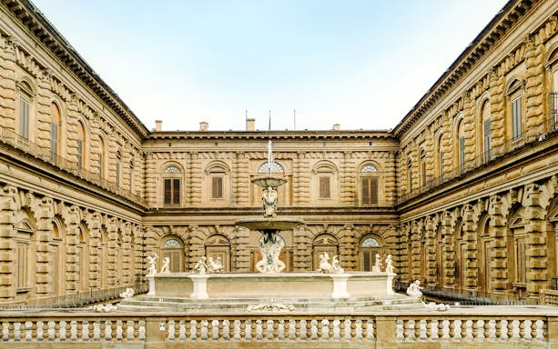 Palazzo Pitti courtyard with fountain and sculptures in Florence, Italy.