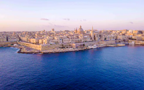 Aerial view of Valletta skyline from Sliema, Malta, featuring historic architecture along the coast.