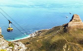 Cable car descending Table Mountain with ocean and Lion's Head view, Cape Town.