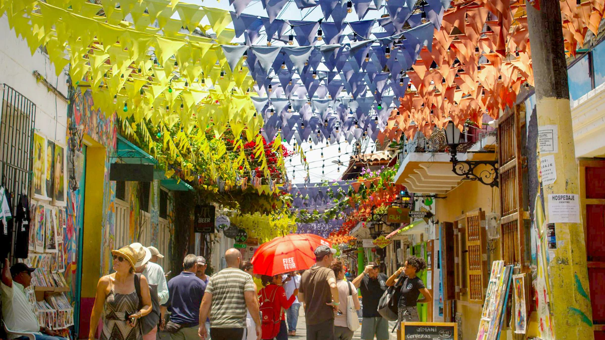 Colorful flags hanging over a busy street in Getsemaní, Cartagena.