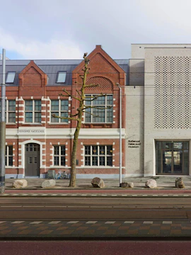 National Holocaust Museum entrance in Amsterdam with brick facade and modern design.