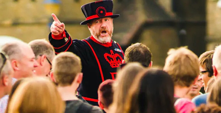 Beefeater leading a tour group at the Tower of London.
