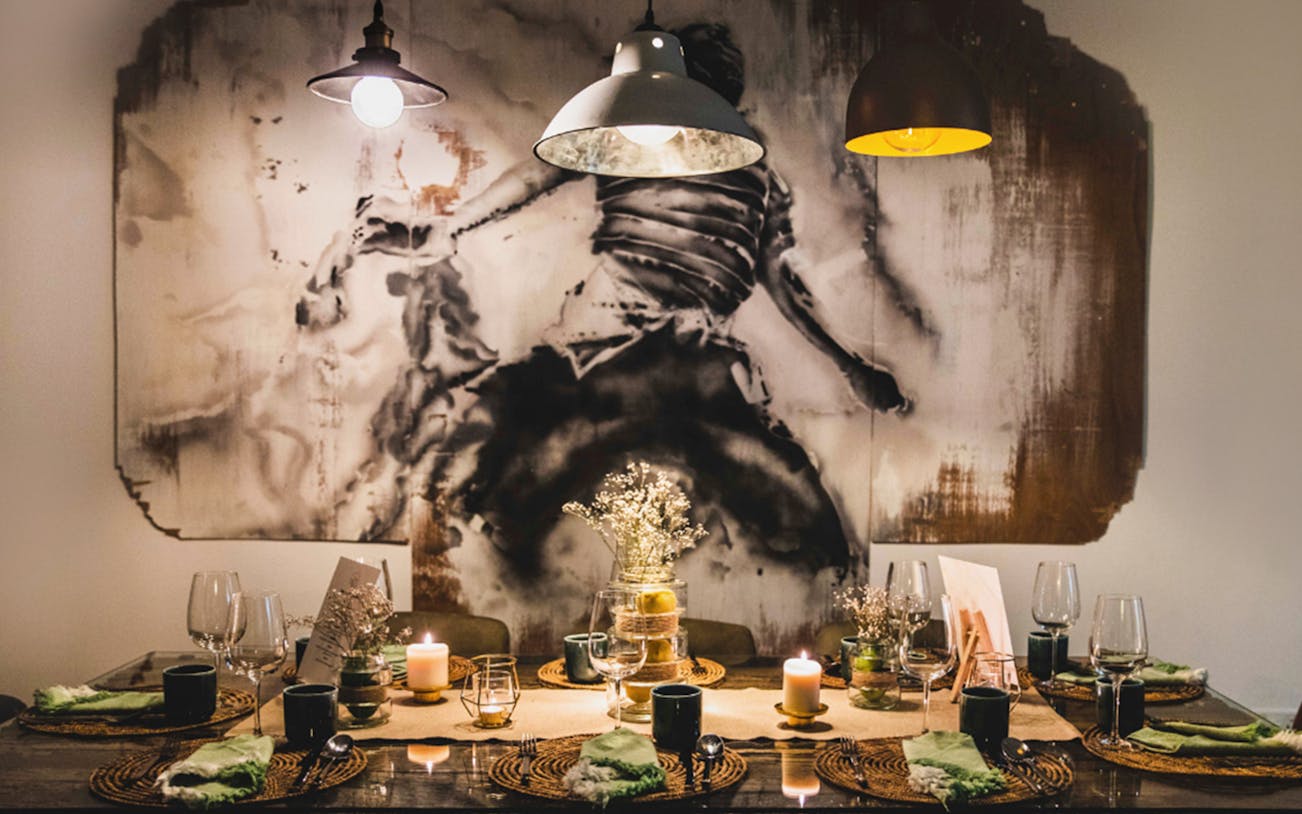 Private dining setup with candles and tableware for a 5-course underground experience.