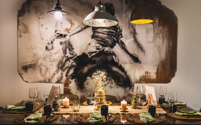 Private dining setup with candles and tableware for a 5-course underground experience.