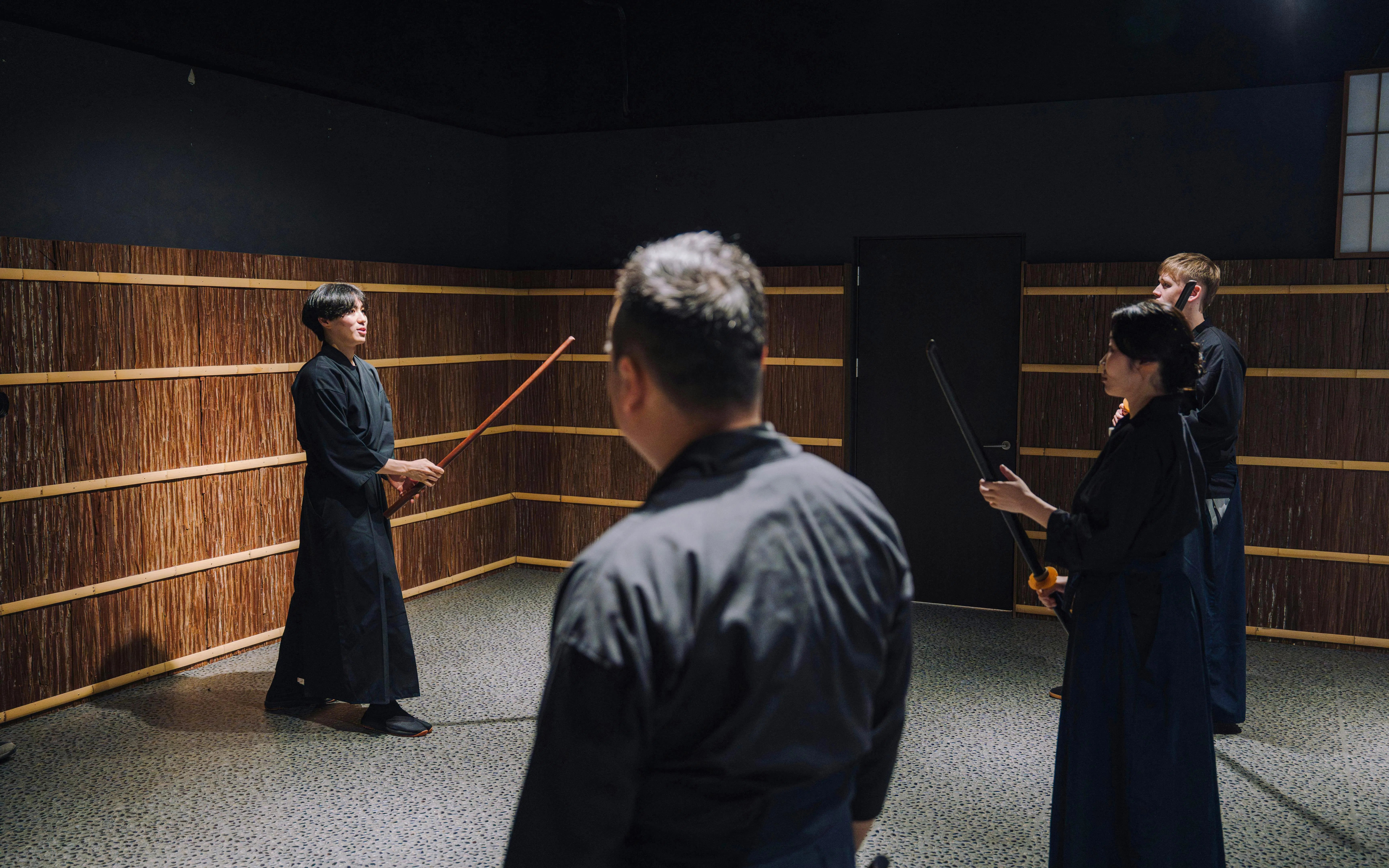 Participants learning stick fighting techniques at Samurai Museum Tokyo.