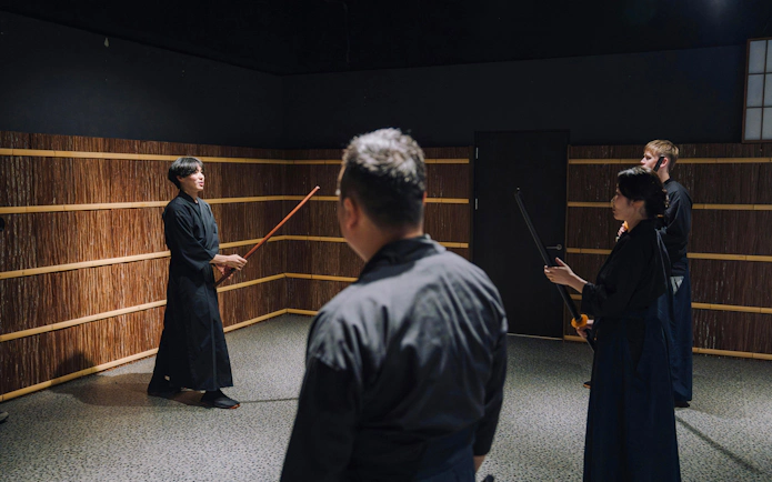 Participants learning stick fighting techniques at Samurai Museum Tokyo.