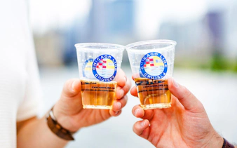 Two people toasting with drinks on a Chicago Architecture Cruise.