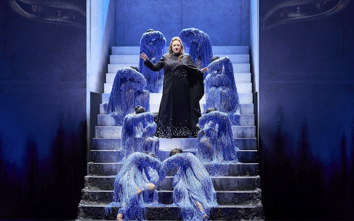 Opera performers in blue costumes on stairs during Turandot show in Sydney.