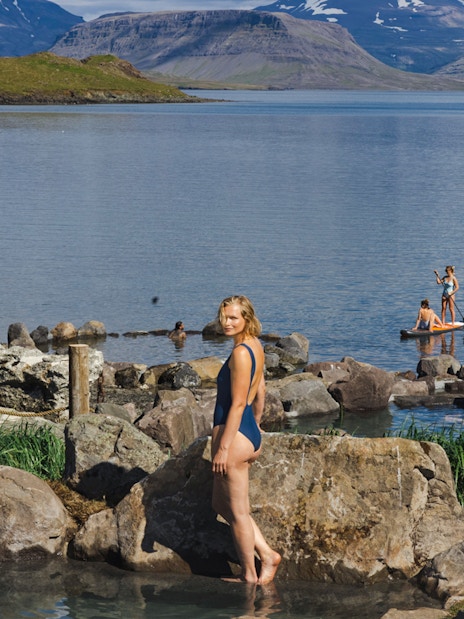 Hvammsvík Hot Spring visitors enjoying geothermal pools and paddleboarding near Reykjavík.