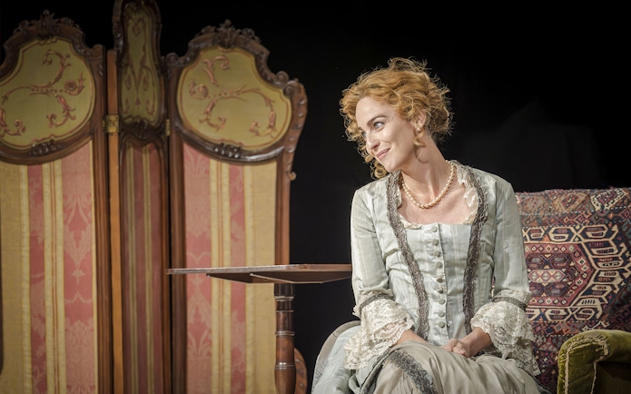 Performer in period costume on stage during Grace Pervades West End show.